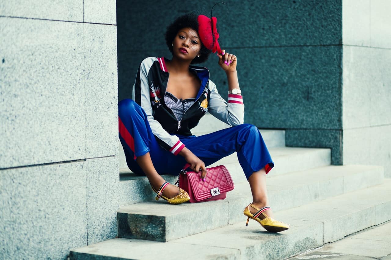 a stylish woman sitting on the stairs
